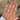 Hand wearing a gold ring with an oval Lab grown diamond on a solitaire engagement ring_Diamond Daughters