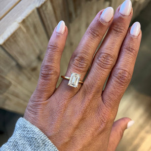 close-up of hand wearing a Emerald Lab Grown Diamond 14k Gold Engagement Ring. Custom engagement ring in San Diego, CA