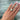 A close-up of a hand wearing a custom-made 14k gold 4.00 carat crisscut cushion lab grown diamond solitaire engagement ring
