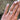 A loose 4.55ct cushion crisscut lab grown diamond resting on the ring finger of a hand